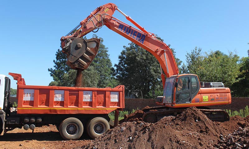A Doosan DX300LCA excavator equipped with an MB Crusher BF90.3 MB bucket crusher crushes material for platforming at a building site in Centurion, South Africa.